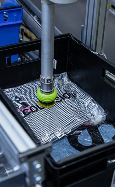 Gros plan d'une pince Nomagic ramassant une chemise